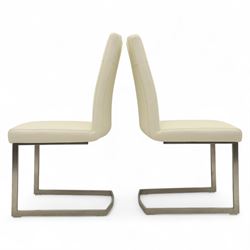 Set of seven contemporary style dining chairs, each with a high padded back and seat upholstered in faux leather on brushed steel sled bases  