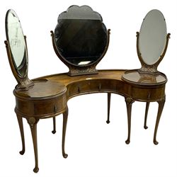 Early 20th century figured walnut kidney shaped dressing table, fitted with central swing mirror on back flanked by bevelled oval mirrors on circular revolving platforms, each on foliate carved supports, fitted with three drawers, raised on cabriole supports with moulded gilt scallop shells, with matching stool