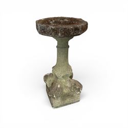 19th century weathered sandstone birdbath, the octagonal canted dished top raised on a ring turned flared pedestal, with four carved stylised dolphins to the squared base
