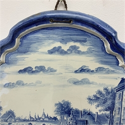 A late 19th century/early 20th century Dutch Deltware blue and white wall plaque, of oval form decorated with a pastoral scene of figures and cattle, H60cm W52cm.