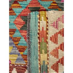 Tibetan-design handwoven rug, deep red field with three central medallions in yellow and blue, traditional yellow key border, white fringes on both ends