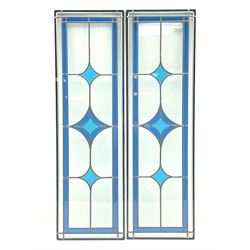Two double glazed stained glass panes, mottled glass with a blue band border and three diamonds 
