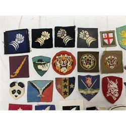 Approximately one-hundred printed and embroidered cloth badges including Royal Tank Regiment, Royal Armoured Corps, 219th Independent Infantry Brigade, Cyrenaica, Cyprus, Singapore and other districts, Gibraltar Garrison, East Anglian Brigade, 20th Armoured Brigade and various armoured divisions etc