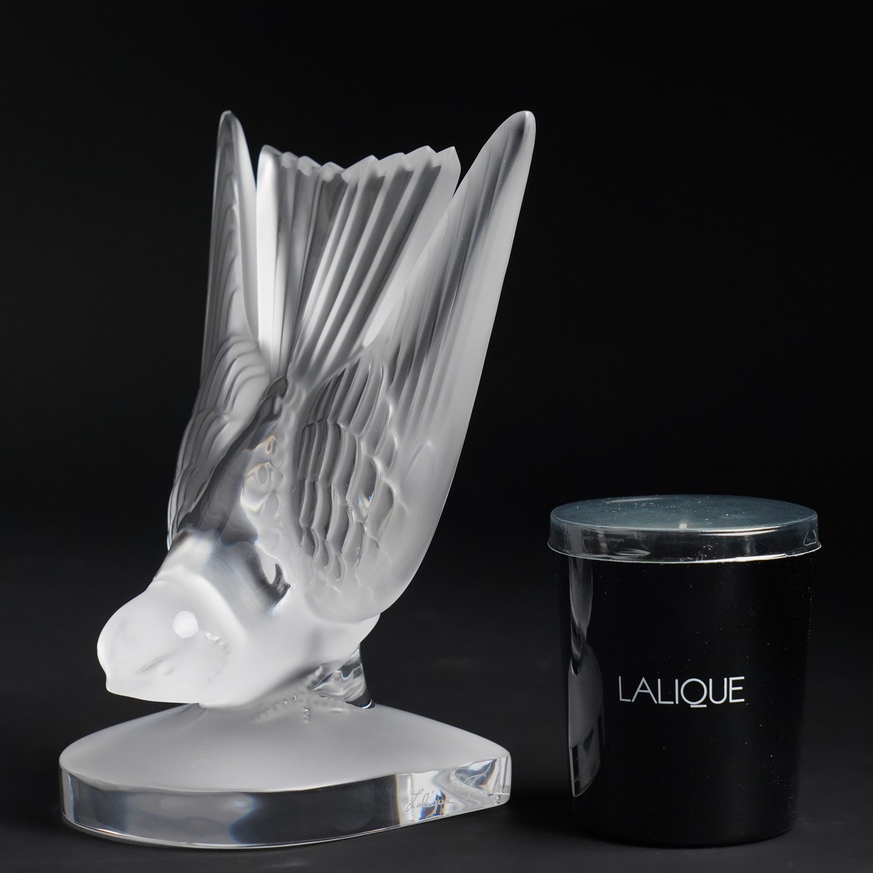 Lalique model of a swallow frosted glass bookend, inscribed 'Lalique France' H15.5, and 'pivoine' scented candle in box (2)
