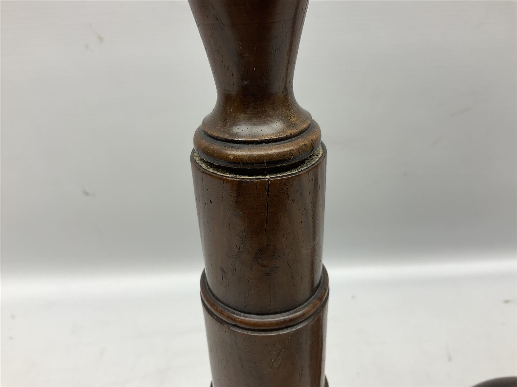 Pair of turned wooden candlesticks, the central column of stepped form raised upon circular spreading base, with drip trays, H56cm