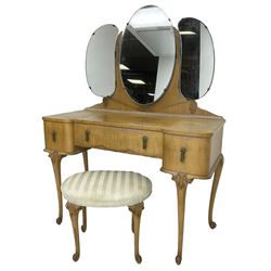 Early to mid-20th century maple eight-piece bedroom suite, decorated with floral urn and trailing linen motifs - triple wardrobe enclosed by three shaped doors, the right-hand side fitted with mirror and slides (W188cm, H195cm, D54cm); dressing table with raised triple mirror back over shaped top, fitted with three drawers, on cabriole supports (W115cm, H153cm, D53cm); oval upholstered dressing table stool on cabriole supports (55cm x 40cm, H44cm); tallboy chest fitted with double cupboard over three drawers (W82cm, H120cm, D53cm); bedside with drop leaf top over single cupboard (W42cm, H69cm, D35cm), pair of bedroom chairs (W45cm, H90cm), 4' 6'' double head and footboards