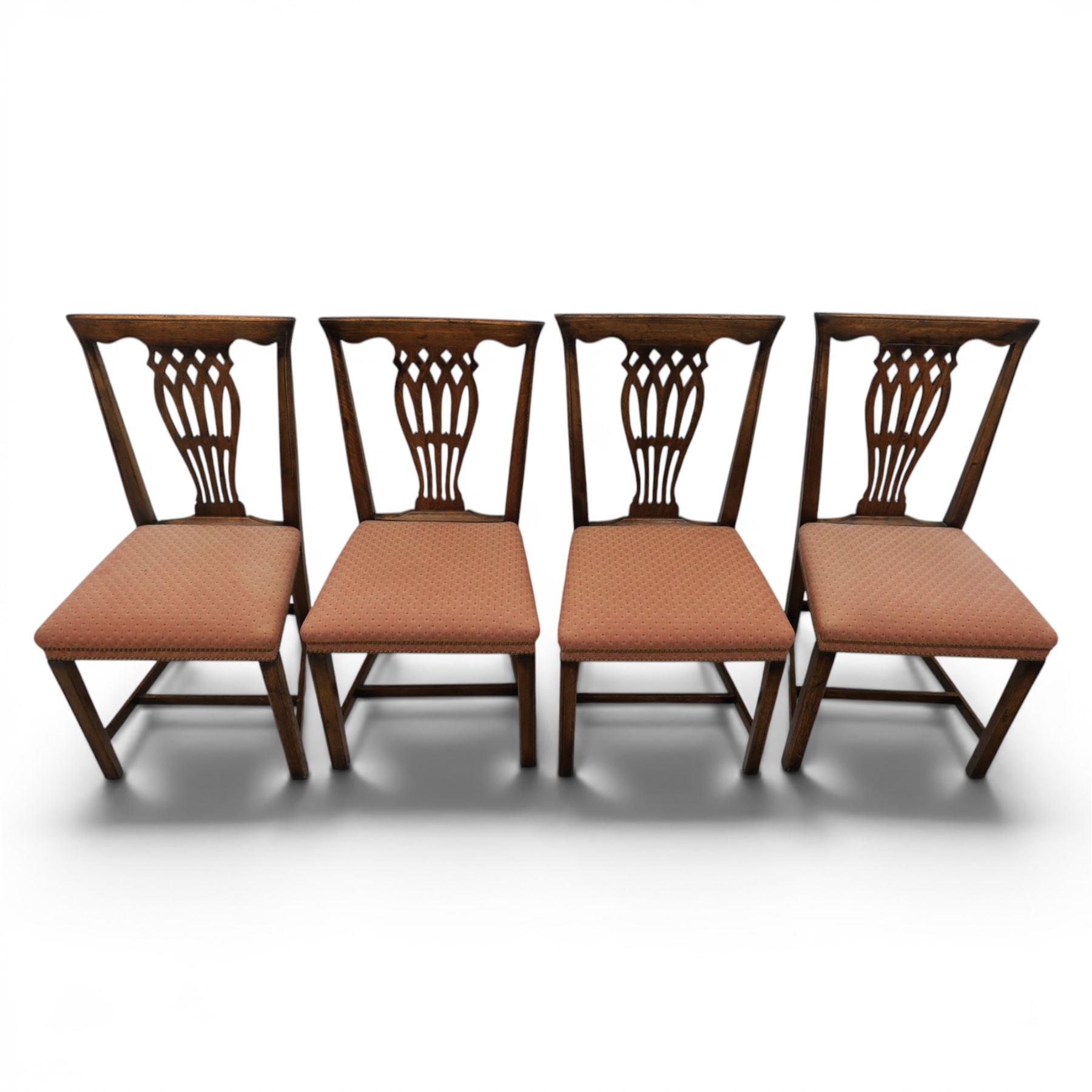 Set of eight George III dining chairs with padded seats, pierced vasiform splat, upholstered seat with brass trim, on square supports with H-stretcher