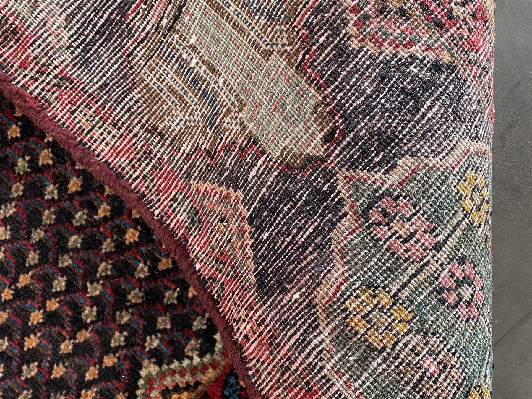 Persian Hamadan blue ground rug, medallion on field decorated with repeating motifs, the guarded border with multiple medallions decorated with flower heads and stylised motifs