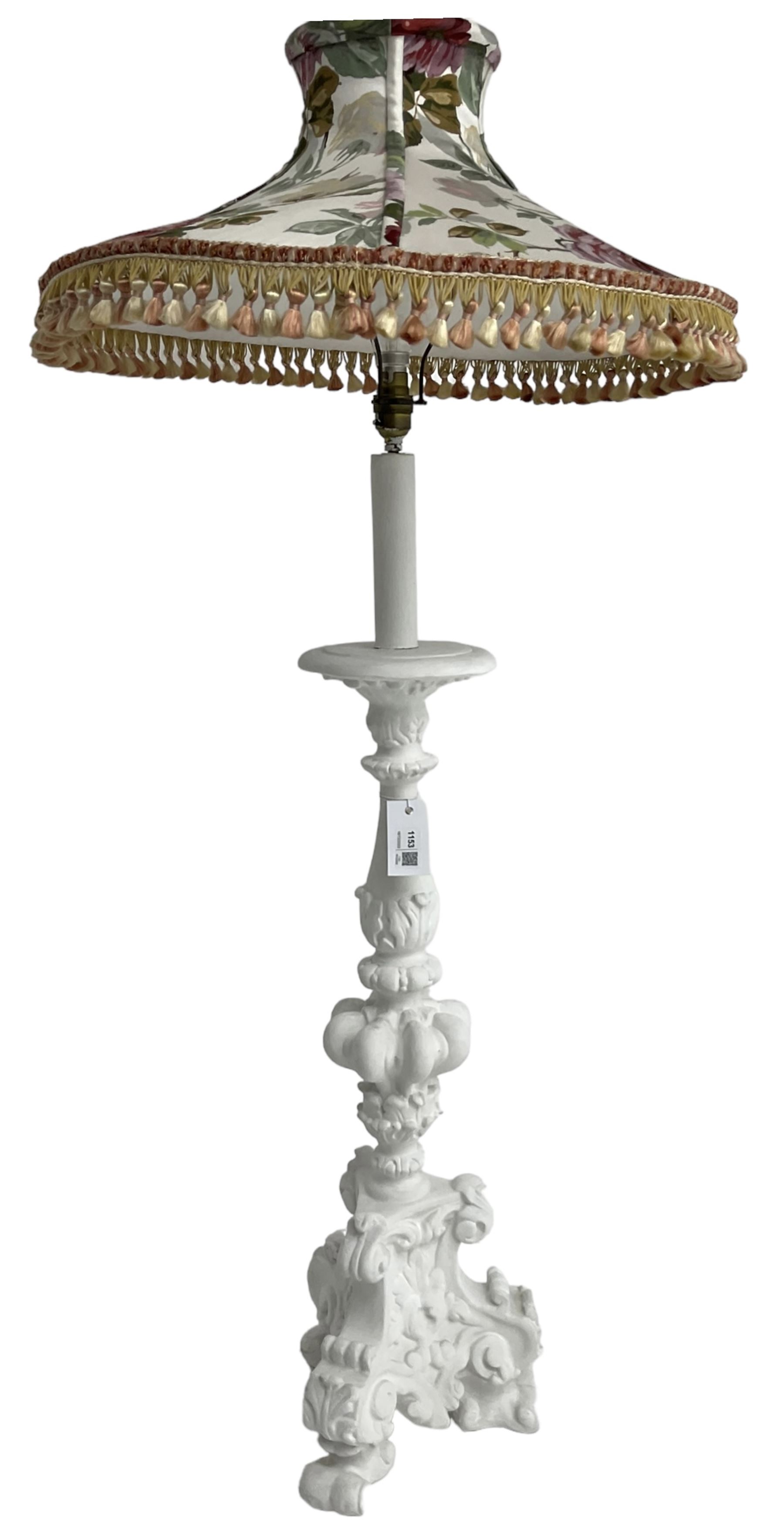 White painted Italian Baroque design standard lamp, ornately cast with foliage and scrolls, on three scrolled feet, with floral shade