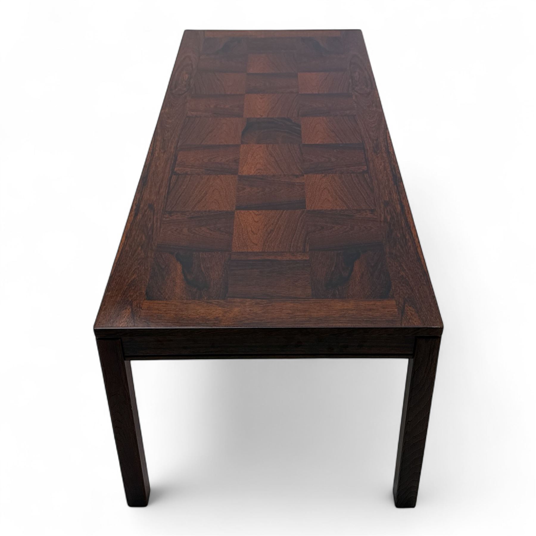 Heggen, Norway - 1970s parquetry veneered rosewood coffee table, the top with 'patchwork' parquetry design, raised on square-section supports