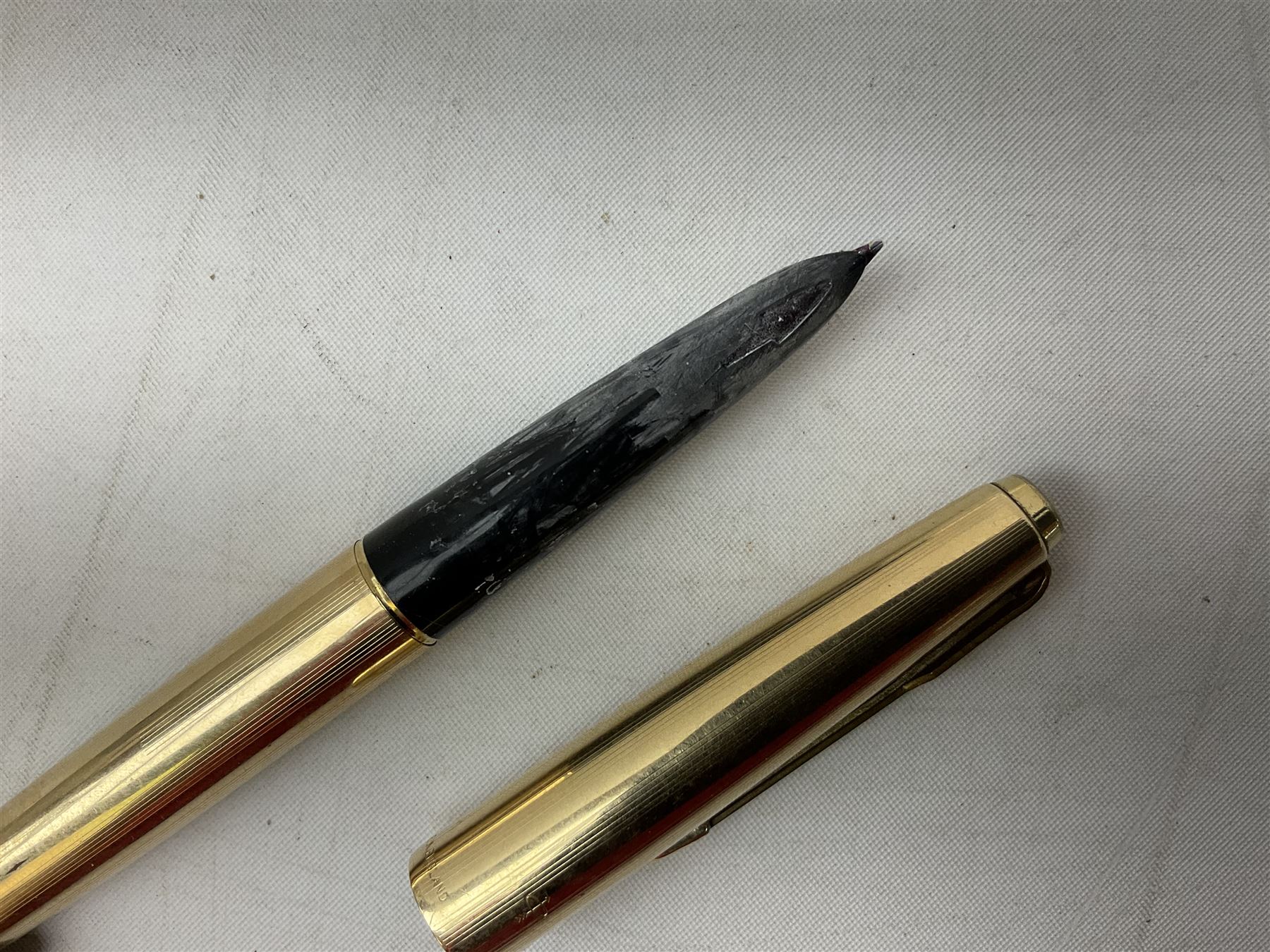 9ct gold propelling pencil with engine turned decoration and vacant cartouche, by S J Rose & Son, stamped 375, L12cm, together with a Parker 12ct rolled gold fountain pen, and two rose gold engine turned propelling pencils to include a rose gold example