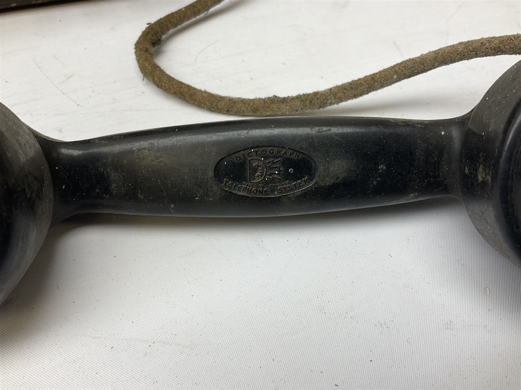 Early-mid 20th century internal telephone system, comprising exchange box with attached TMC rotary telephone and dictograph with Bakelite handset and support upon stained wood case, and 1960s black Bakelite telephone model 312L with G.P.O sticker beneath, largest H30.5cm W36.5cm D30cm