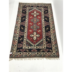 Persian style beige ground rug, field of four medallions, 237cm x 149cm 