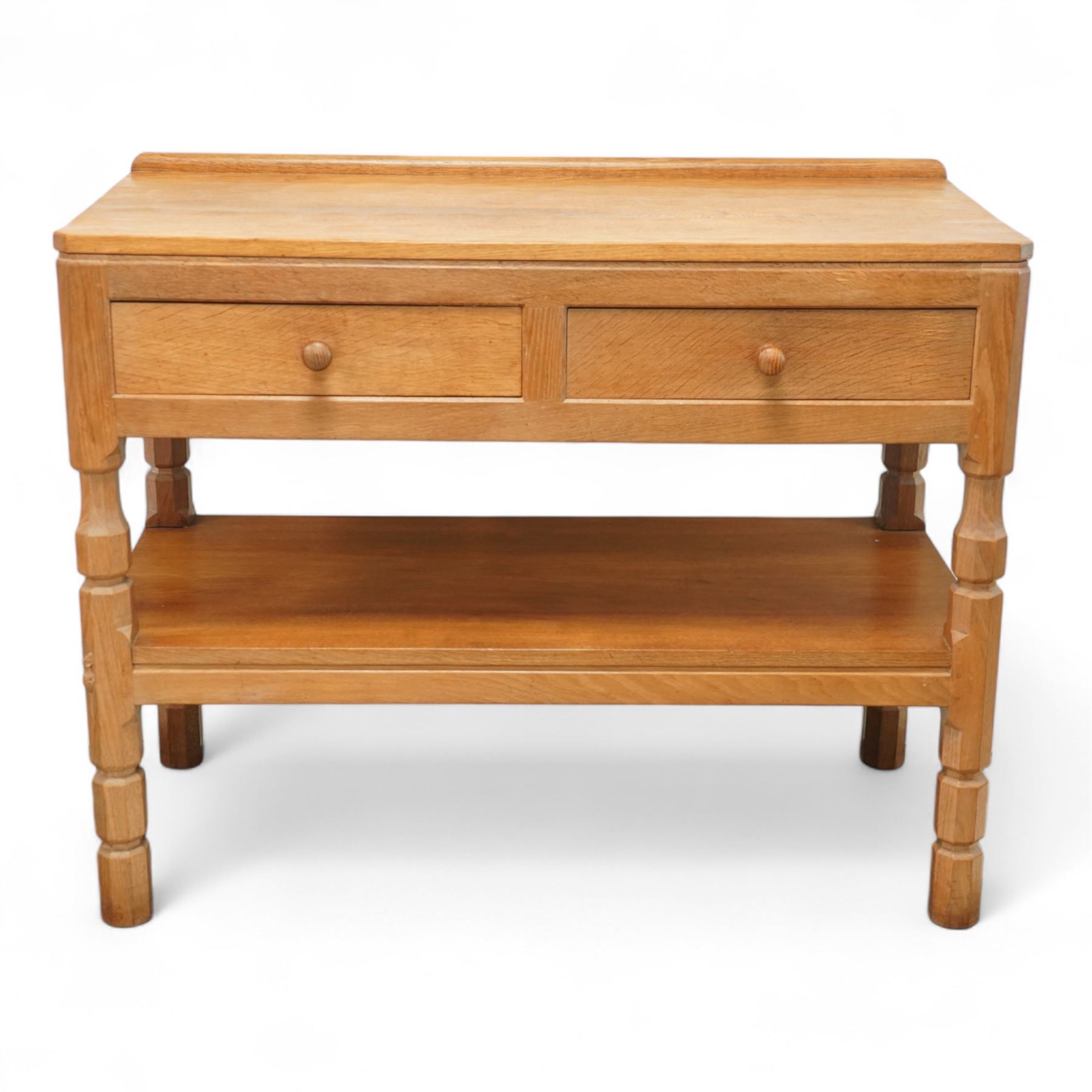 Mouseman - oak side table or buffet, raised back over rectangular canted adzed top, fitted with two drawers, raised on four octagonal turned supports united by undertier, carved with mouse signature, by the workshop of Robert Thompson, Kilburn 