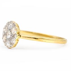 Early 20th century diamond daisy cluster ring, milgrain and bead set with thirteen old cut diamonds by Ahronsberg Brothers, stamped 18ct, total diamond weight approx 0.45 carat