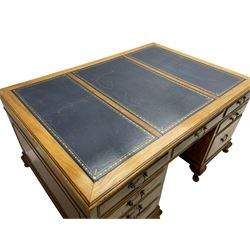 Early 20th century mahogany twin pedestal desk, the moulded rectangular top with three sectional leather insets with gilt decoration, fitted with eight drawers, on cabriole feet