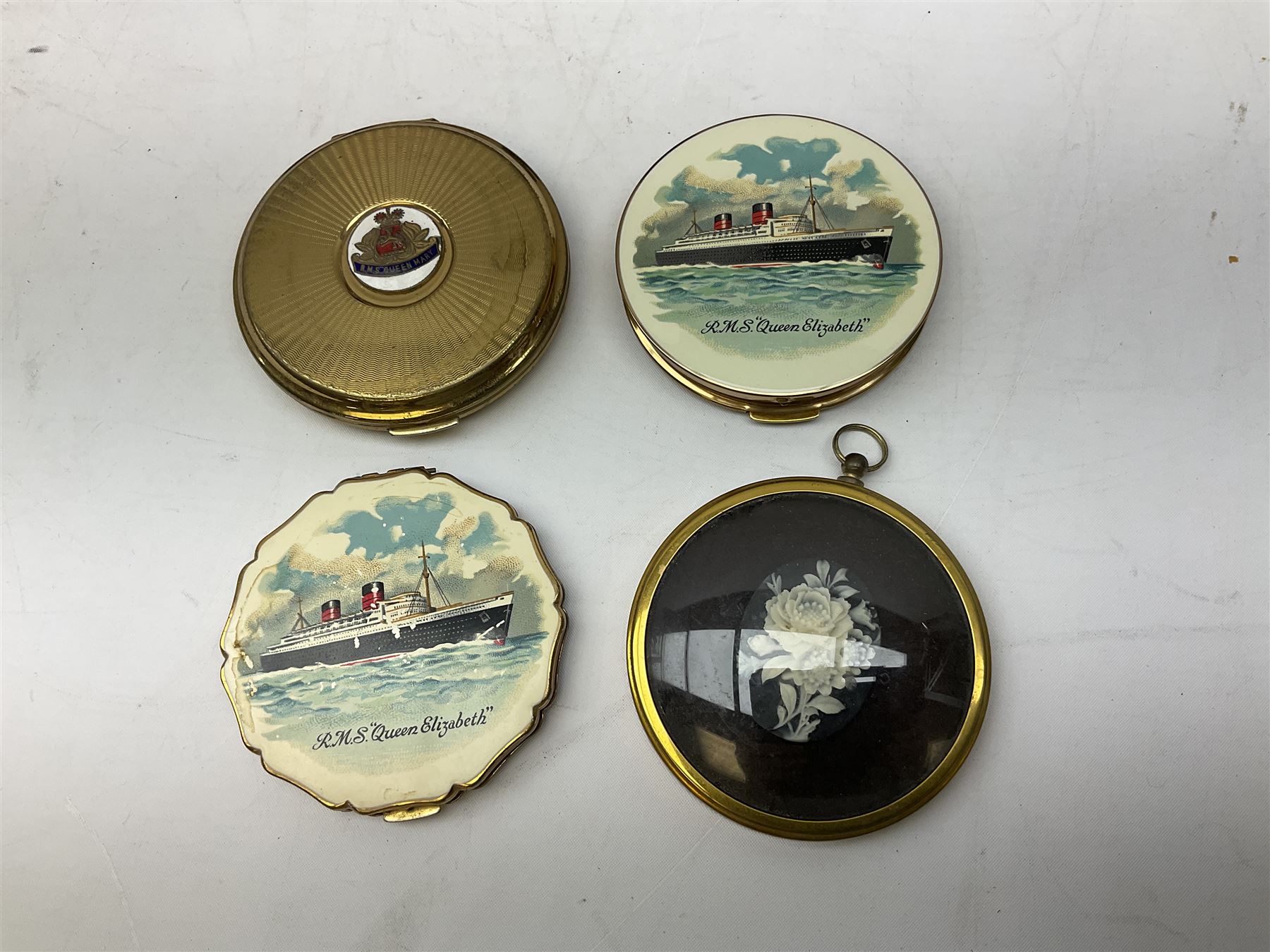 Silver 1969 Cunard RMS Queen Elizabeth maiden voyage commemorative medallion, in original Slade, Hampton & Son case with certificate, two Stratton R.M.S Queen Elizabeth mirror compacts, Stratton R.M.S Queen Mary compact, mid 20th century P&O Canberra Round World Voyage miniature globe, S.S Oriana ash tray modelled as a barrel, Norah Wellings sailor doll, and other maritime and shipping memorabilia 