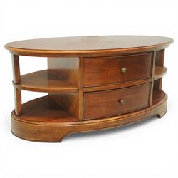 Willis & Gambier - oval coffee table, the moulded oval top above two central frieze drawers with handles either side, flanked by open shelves, raised on a shaped plinth base