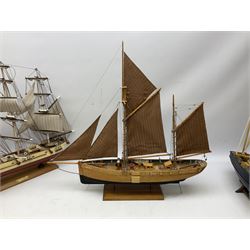 Eight model ships or boats including fishing boat with fish, nets and buoyancy aid, two mast sailing ship complete with cannons, two mast yacht with detailed rigging and life boat etc, the largest L72cm, H60cm
