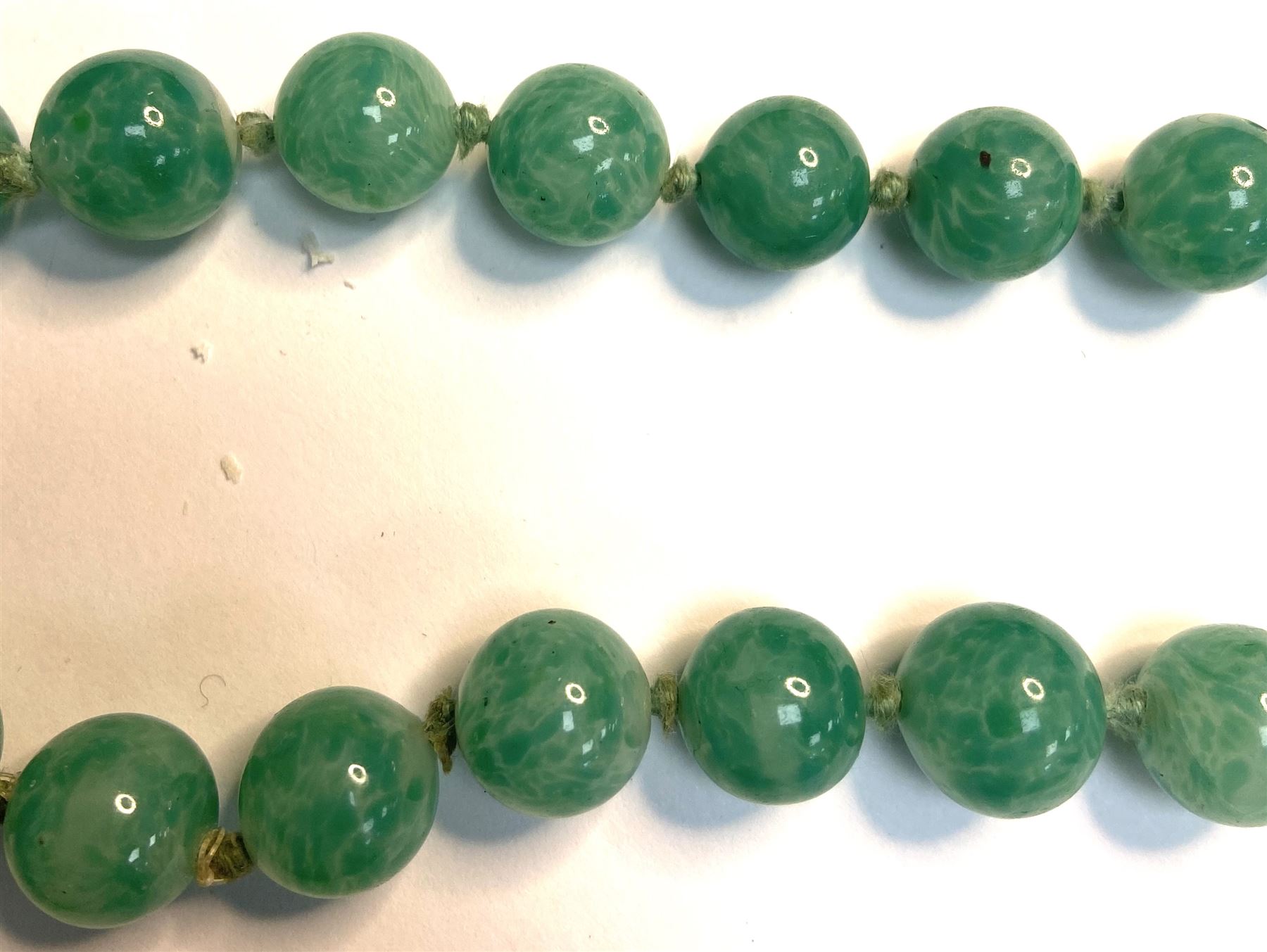 Chinese jade bead necklace with silver open work clasp with a cabochon greenstone/possibly jade bead necklace, signed Liu with Chinese character marks