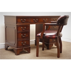  Reproduction mahogany twin pedestal office desk, tooled maroon leather inset top, eight drawers, bracket supports (W122cm, H78cm, D60cm) with chesterfield style desk chair, upholstered in deep buttoned maroon fabric (W58cm) (2)  