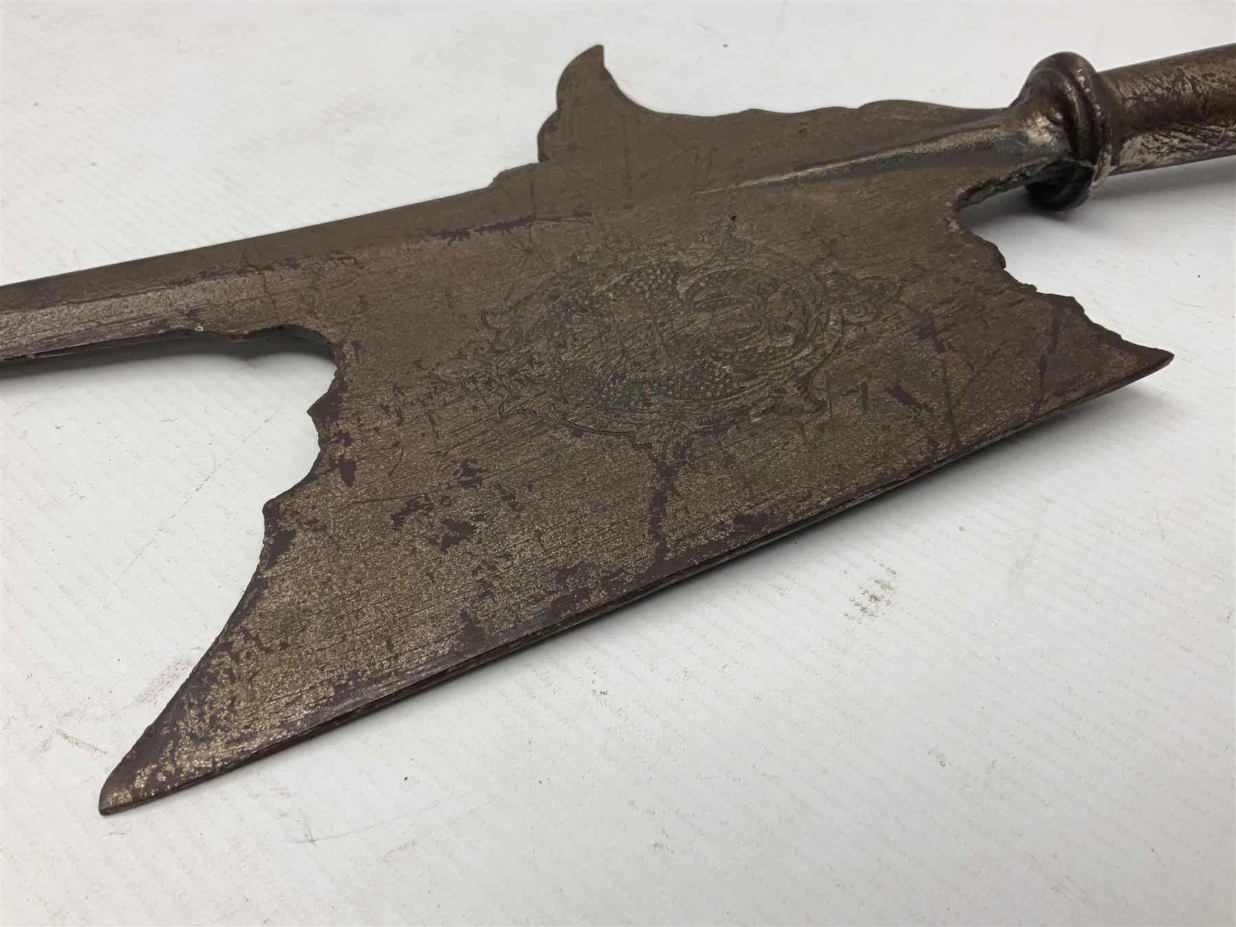 Moroccan jambiya dagger with 24.5cm plain curved blade stamped LONDON to the ricasso area, the hilt and scabbard overlaid with plain sheet brass to the back and ornate silver coloured metal to the front; waisted grip and arched pommel; two pyramid mounts to the scabbard L41cm overall; large billhook with curving blade and stacked leather washer grip; and a reproduction halberd blade (3)