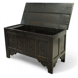 19th century carved oak coffer, rectangular plank top above a four-panel front carved with lozenges and flowerhead motifs, shaped lower apron and stile feet