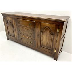Mid to late century oak dresser base, three graduating drawers flanked by two cupboards, stile supports 