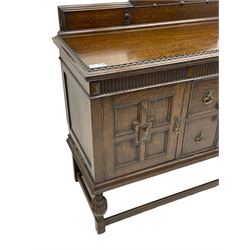 Early 20th century oak sideboard, raised stepped arch back over moulded rectangular top, fitted with two drawers and two panelled cupboards with geometric mouldings, on turned and lobe carved baluster feet united by stretchers 