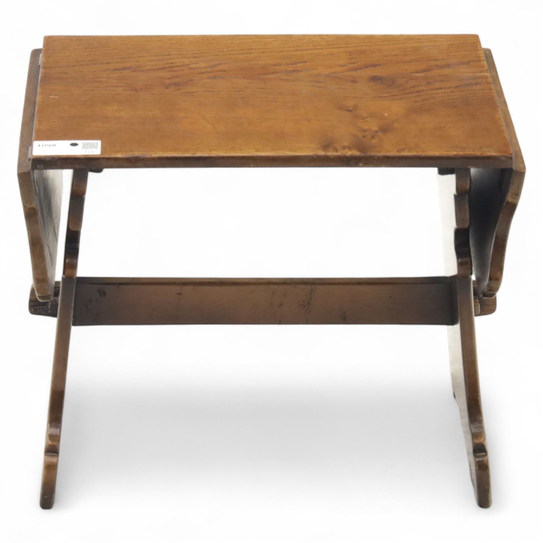 Early 20th century oak drop leaf cottage table, rectangular top with twin hinged leaves, on shaped trestle end supports united by central stretcher
