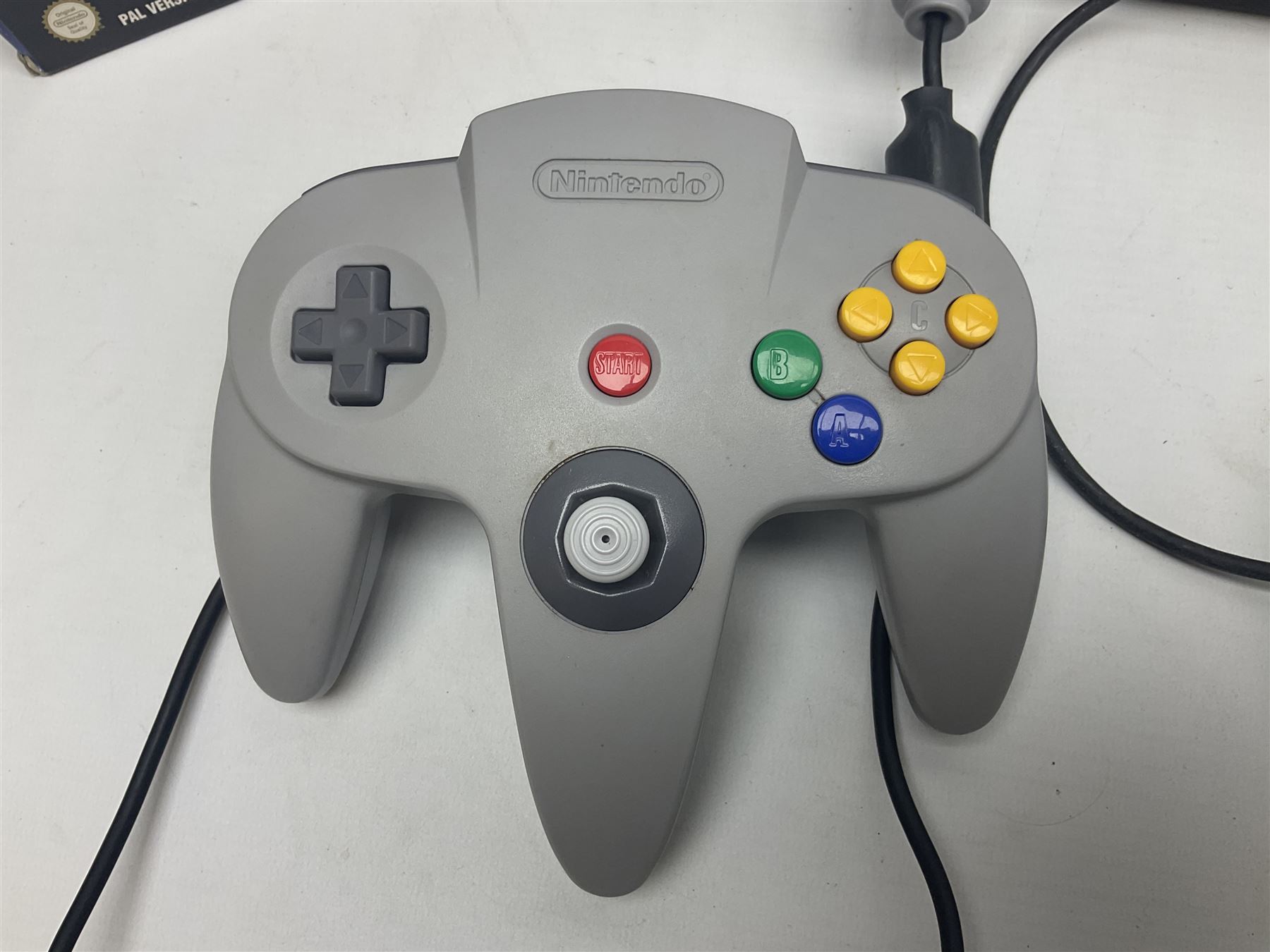 Nintendo 64 console, two controllers, games and accessories. Accessories to include the ‘Tremorpak’ and ‘Spook’ 2 Phono plugs and a S-VHS plug with adapter, both in original boxes. Games to include ‘Golden Eye 007’, ‘Doom 64’, ‘Killer Instinct Gold’, ‘Tetrisphere’, ‘F-1 World Grand Prix’, ‘Pilotwings 64’ and ‘Lylatwars’ with ‘Rumble Pak’, all with original boxes and instruction manuals. ‘Star Wars Episode I Racer’ game cartridge in Shadows of the Empire box. 