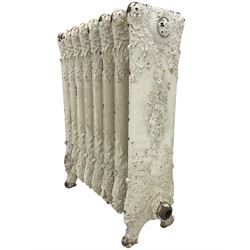 Victorian white painted cast iron radiator, decorated with trailing leafy branches and flowerheads
