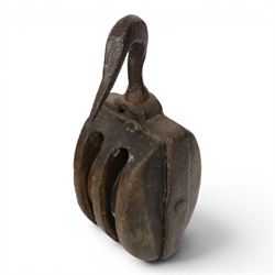 19th century double-sheave wooden pulley block in a metal casing, fitted with an iron hook...
