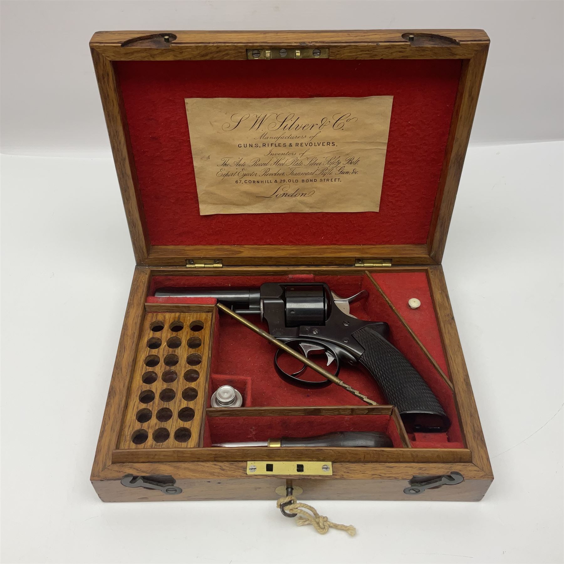Scarce Webley & Scott .430 short six-shot revolver retailed by S.W. Silver & Co of Cornhill, London; round barrel with captive swivel ejector under; chequered walnut one-piece grip; numbered 12627 with various maker's marks L26cm overall; in fitted oak case with trade label to lid, cleaning rod, screw-driver and oil bottle