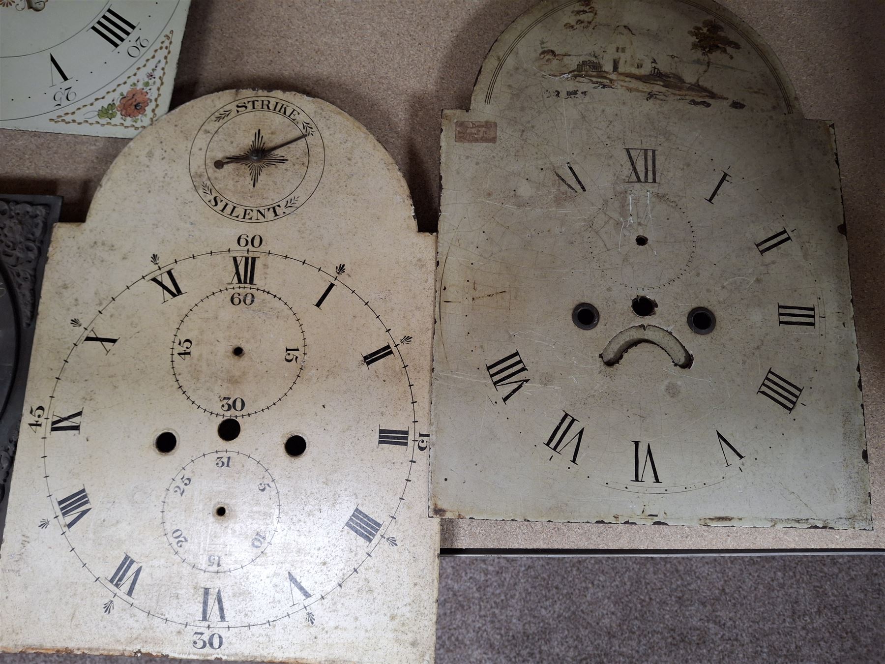 Approximately twenty-two longcase and wall clock dials, 18th century and later, included painted and brass examples