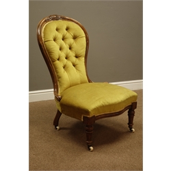  Victorian mahogany framed spoon back nursing chair, carved cresting rail, upholstered serpentine seat and buttoned back, turned and fluted feet, ceramic and brass castors, H97cm  