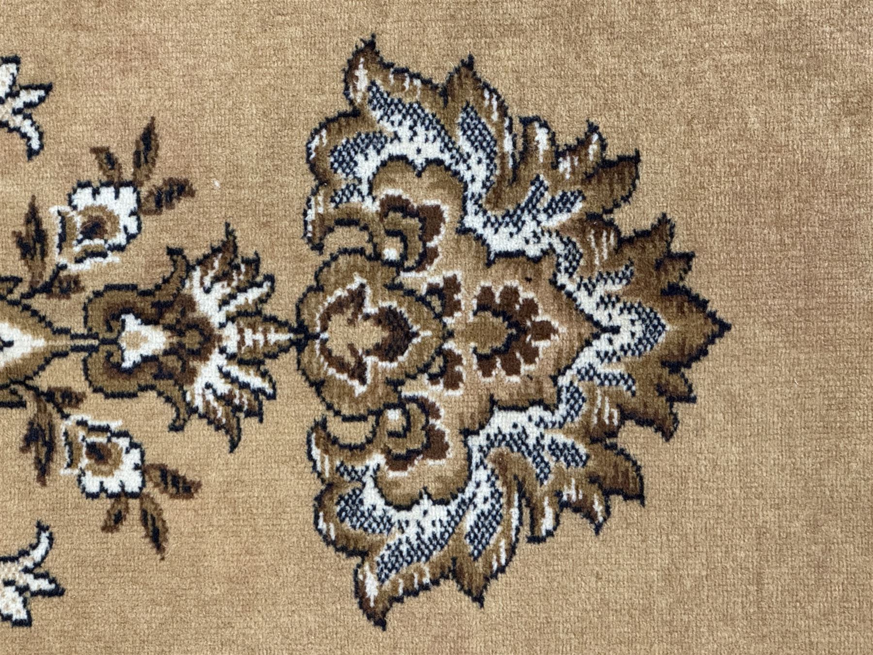 Persian design golden beige ground rug, the field with symmetrical scrolling foliate and floral designs, central floral medallion, bordered by a multi-layered band with floral and vine patterns in contrasting beige and dark brown tones