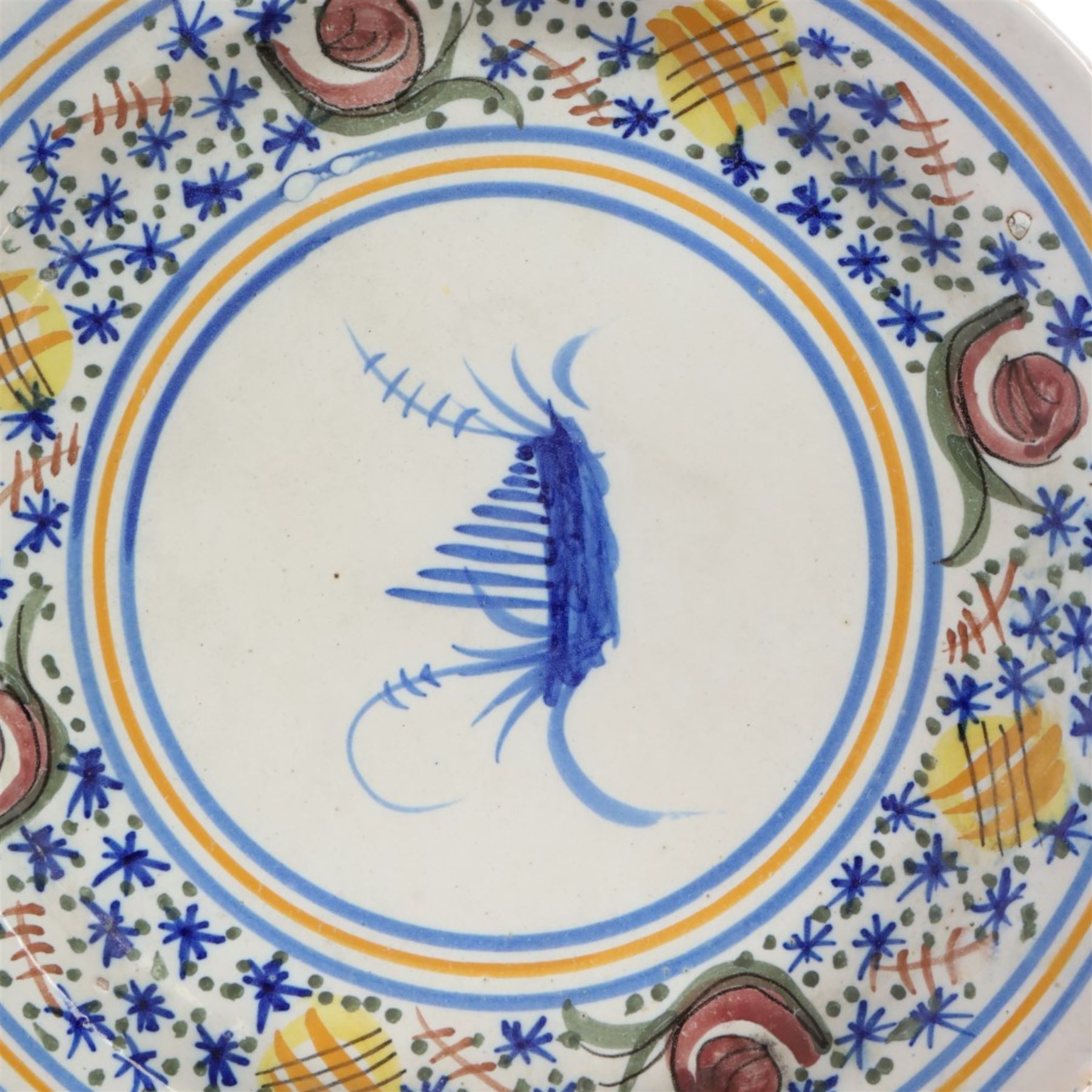 Pair of 20th century Spanish tin glazed polychrome plates, each painted with central foliate spray, within a stylised border, D32cm 