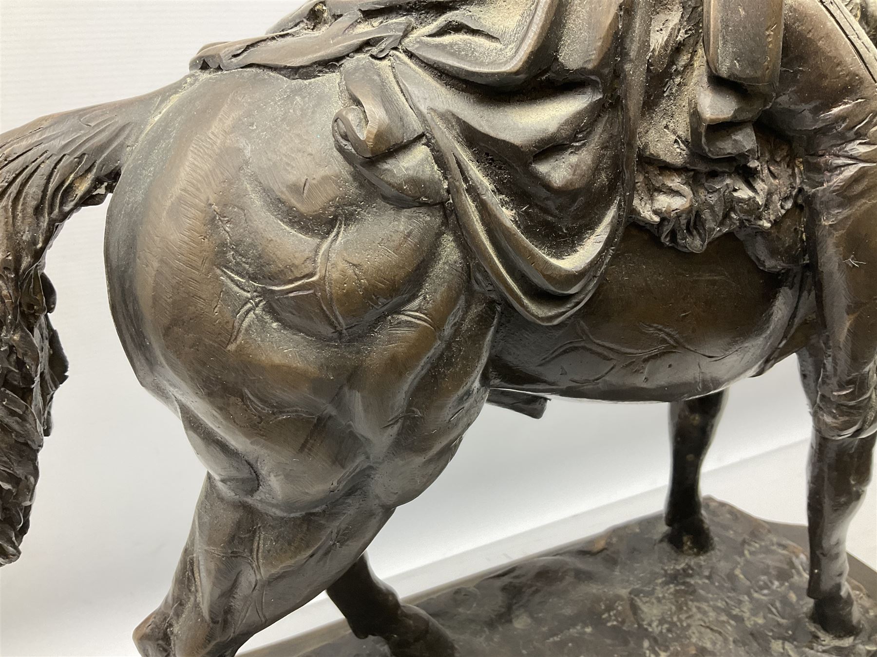 Large and impressive bronze figure of Wellington seated on a horse, on a sarcophogus shaped stepped base impressed 'Meunier Paris', the canted corners inset with battle trophies H68cm L50cm D22cm