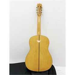 A Hondo guitar, with a 'Protection Racket' classcal 7052 case.