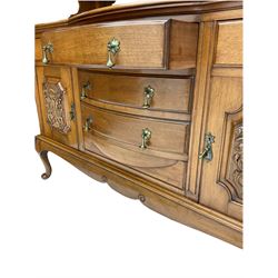 Late Victorian walnut mirror back sideboard or dresser, the raised back fitted with two curved and lead glazed cabinets, central arched bevelled mirror, the sideboard with break bowfront, fitted with six drawers and two cupboards, the cupboard doors panelled and carved with scrolls, shell and plant motifs, shaped apron with cabriole feet
