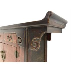 Chinese style Alter side cabinet, fitted with two drawers and cupboard, distressed red lacquered finish, fret work decorated brackets 
