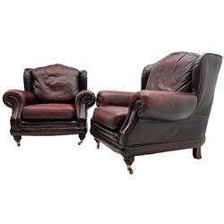 Thomas Lloyd - three-piece lounge suite, comprising of traditional shape two seat sofa (W190cm H80cm) and a pair of wingback armchairs (W100cm H91cm), each with rolled arms over turned supports with brass castors, upholstered in oxblood red leather