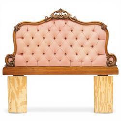 Two 20th century headboards, one with scrolled rail above a pink button backed board (H c127m, W 137cm) the second with flamed mahogany veneer (H 117cm, W 163cm)