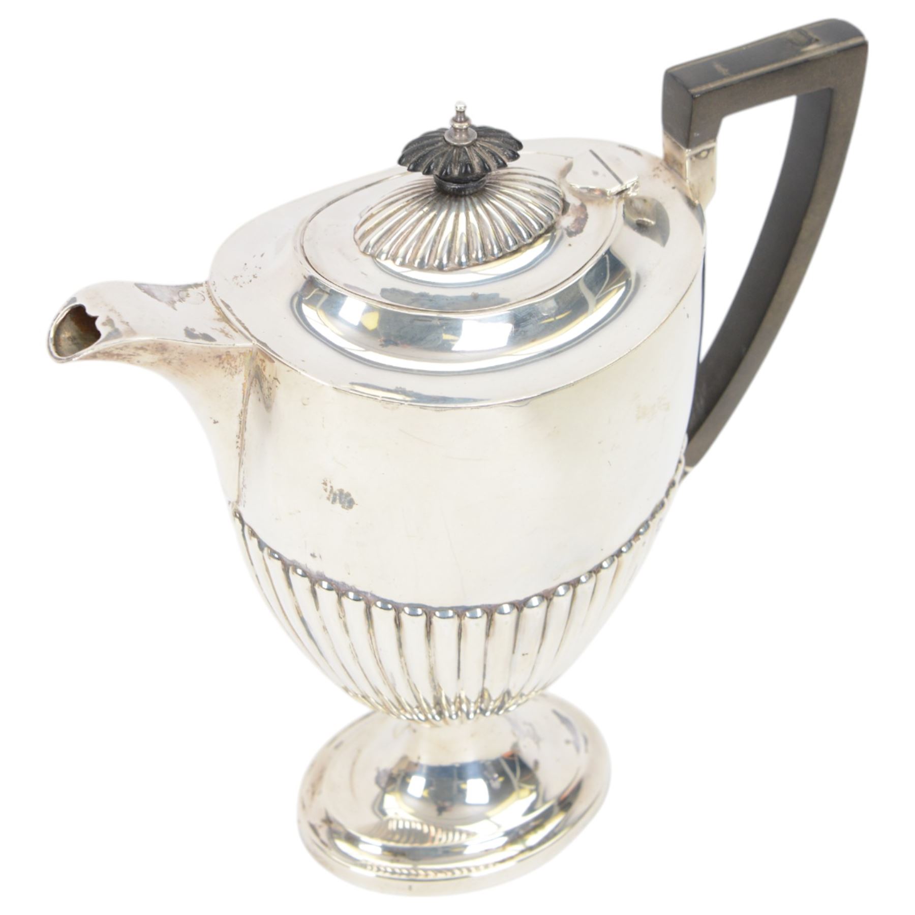 Early 20th century four piece silver tea service, comprising teapot, hot water pot, open sucrier and milk jug, all of oval part fluted form, the teapot and hot water pot with Bakelite type handles and finials, hallmarked James Deakin & Sons (John & William F Deakin), Sheffield 1918