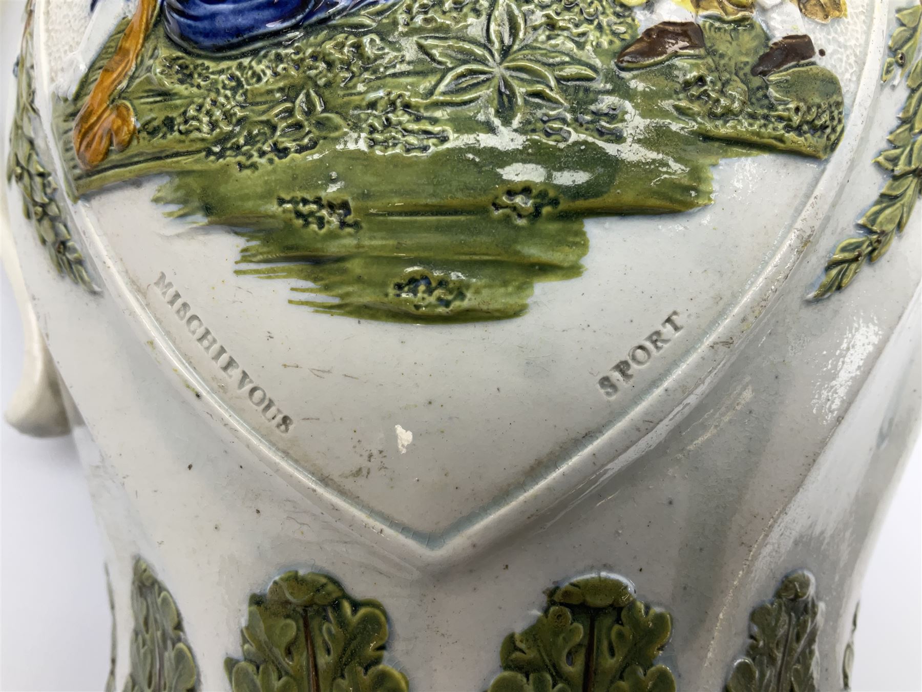 Early 19th century Prattware jug, circa 1800, decorated with two heart shaped panels of children, titled Sportive Innocence and Mischievous Sport, further decorated with acanthus and foliate borders, H22cm