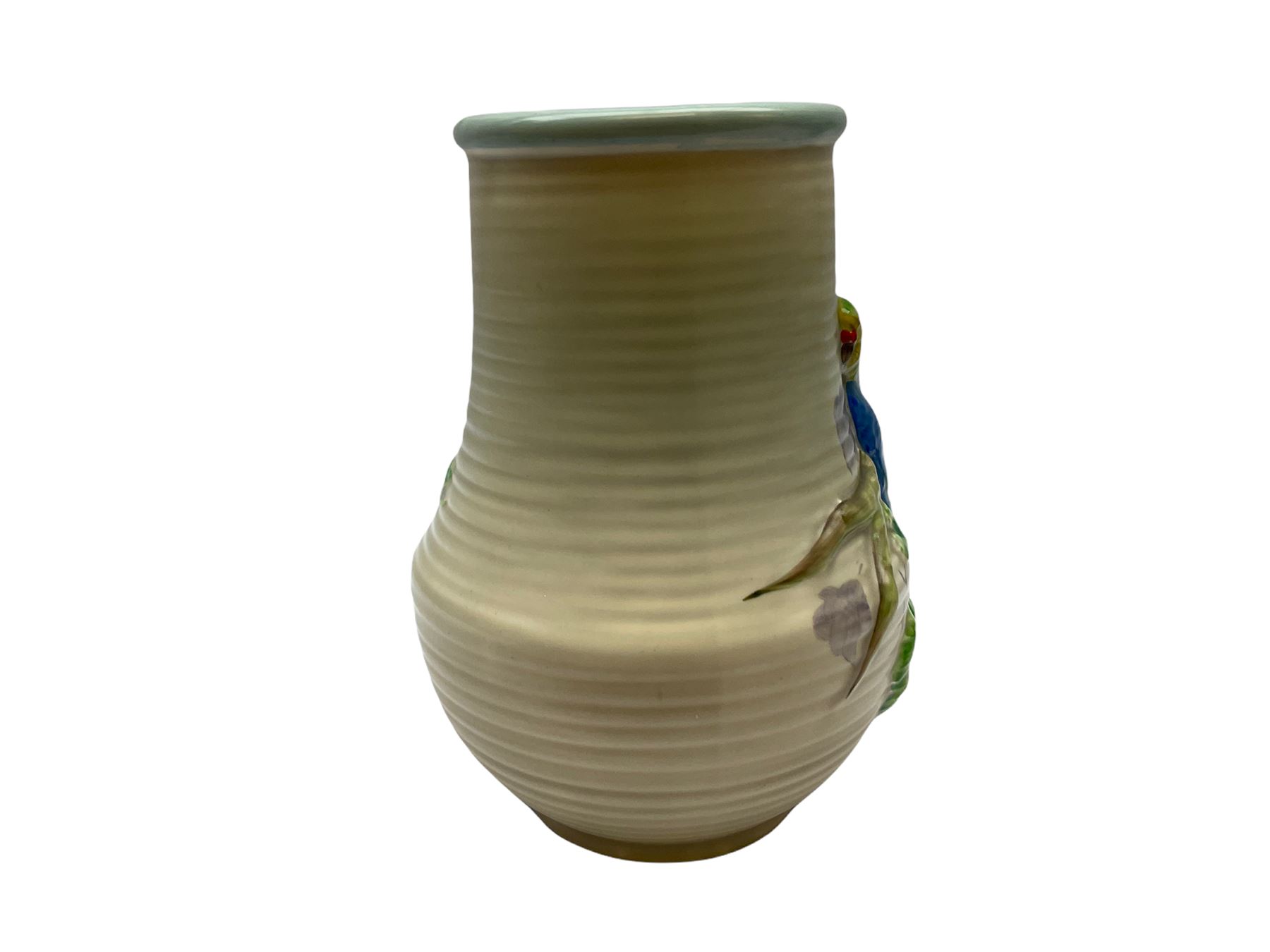 Clarice Cliff baluster jug moulded with a blue budgerigar perched upon branch with green rustic handle and mushroom glaze,  factory stamped beneath, H22.5cm