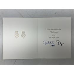 H.M. Queen Elizabeth II and HRH the Duke of Edinburgh - 1987 Christmas card with printed photographic front of a Royal Family group, the inside with two cyphers and signed Elizabeth R and Philip with manuscript date 1987 below