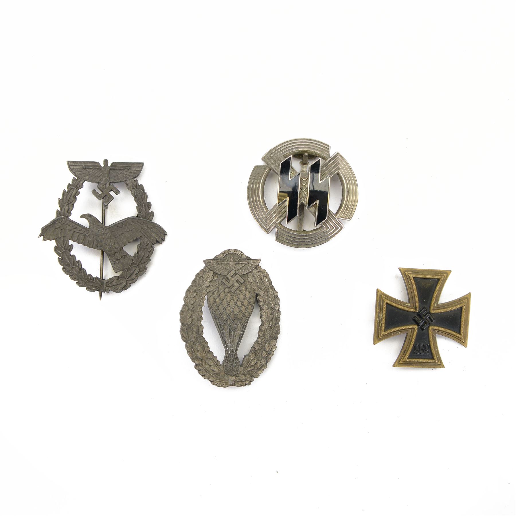 Four German style badges, including Iron Cross, German Proficiency SS runes badge, etc together with a reproduction German cap 