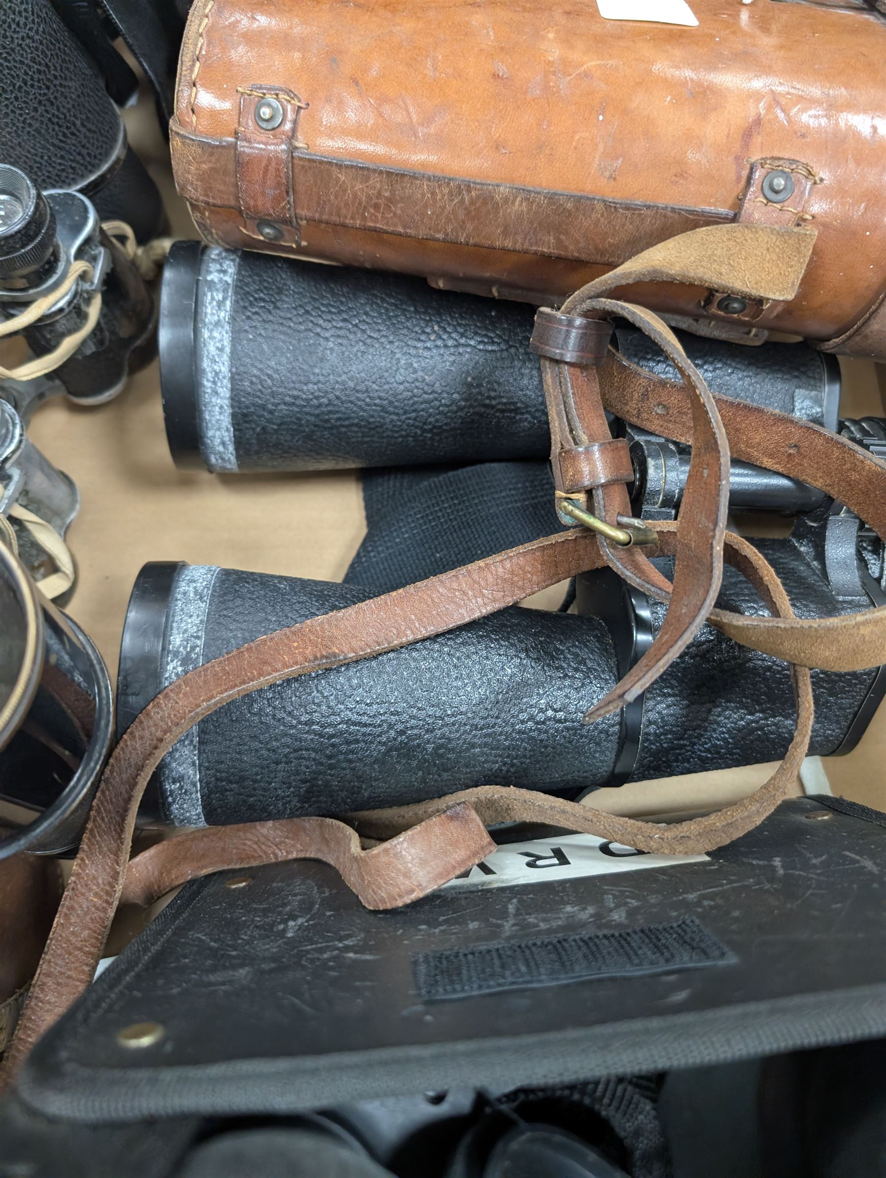 Nine pairs of early 20th century and later binoculars, including Tento 20x50, Nagoya Panoramic 8 x 30, Orr & Sons Madras, DRW 10 x 50, etc some with cases